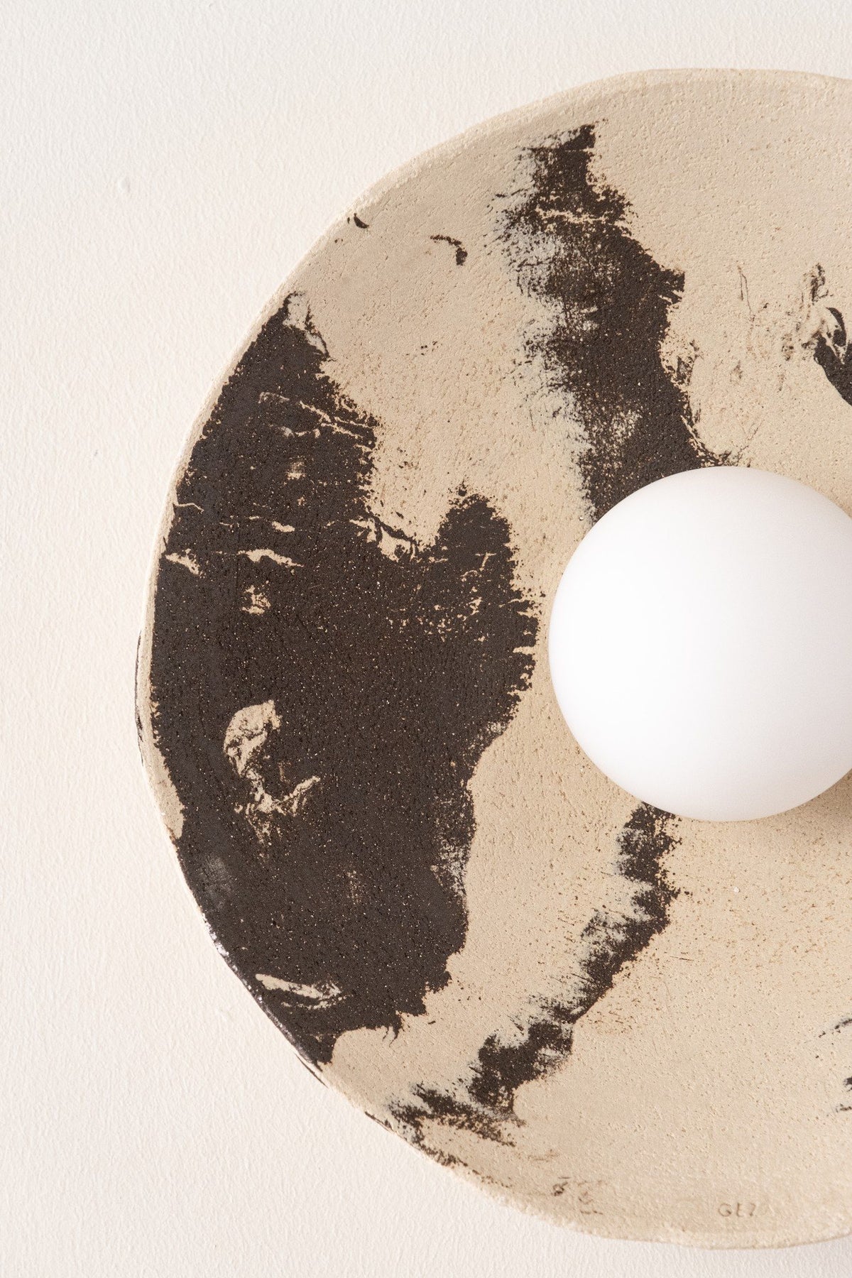 Close-up of the Nara ceramic shade with hand-painted dark brown brushstrokes on natural cream clay