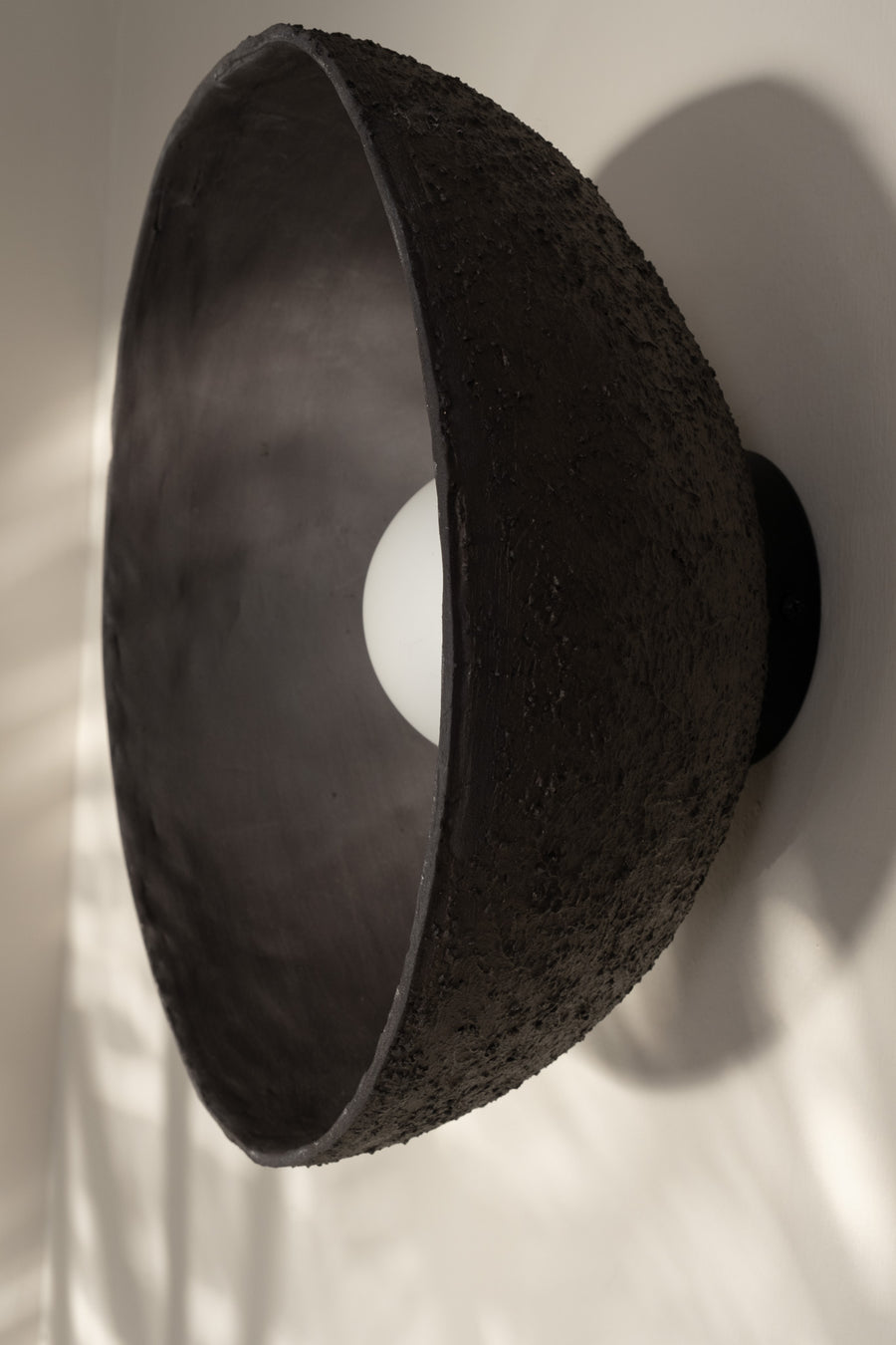 Astra – handmade black ceramic wall sconce in natural stoneware clay by Geza Ceramic Studio