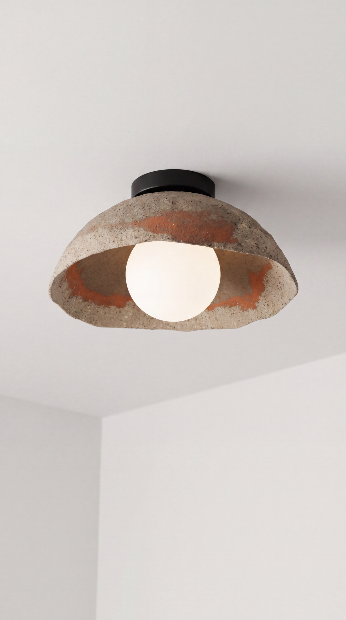 Kaya handmade ceramic flush mount ceiling light with stone texture, terracotta tones and black canopy