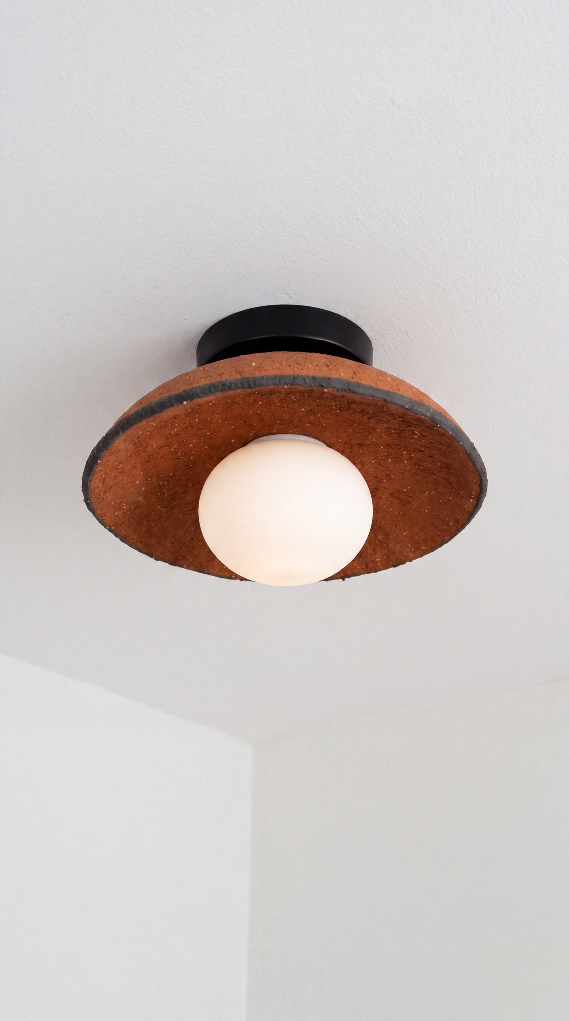 Ember handmade terracotta ceramic flush mount ceiling light with charcoal rim, black canopy and opal globe