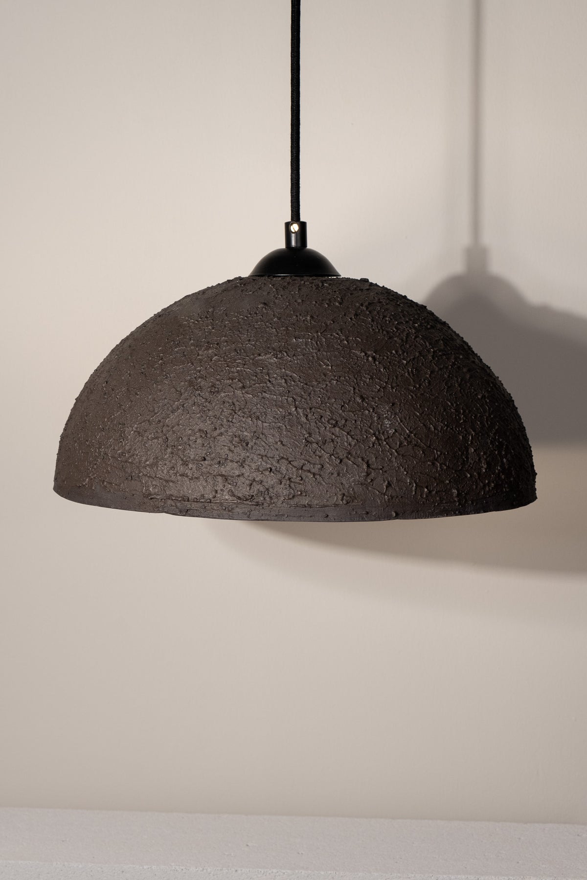 Nomi – handmade black ceramic pendant light in natural stoneware clay by Geza Ceramic Studio