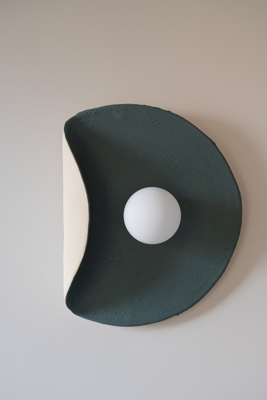 Noma – handmade dark green ceramic wall sconce in natural stoneware clay by Geza Ceramic Studio