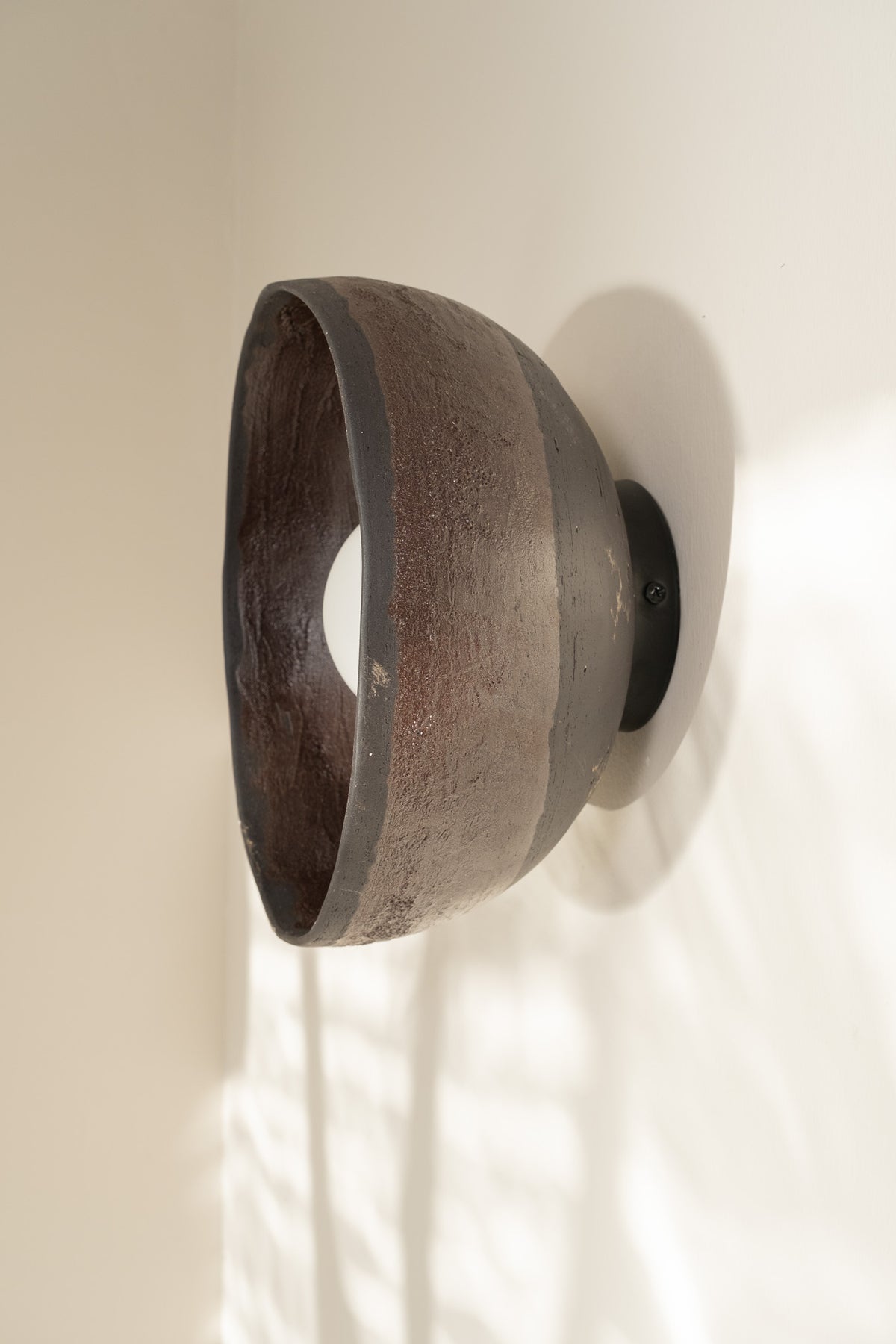 Cyris – handmade black ceramic wall sconce in natural stoneware clay by Geza Ceramic Studio