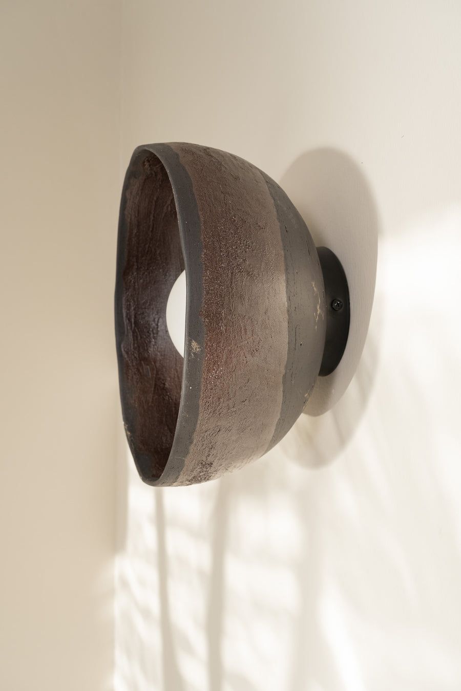 Cyris – handmade black ceramic wall sconce in natural stoneware clay by Geza Ceramic Studio