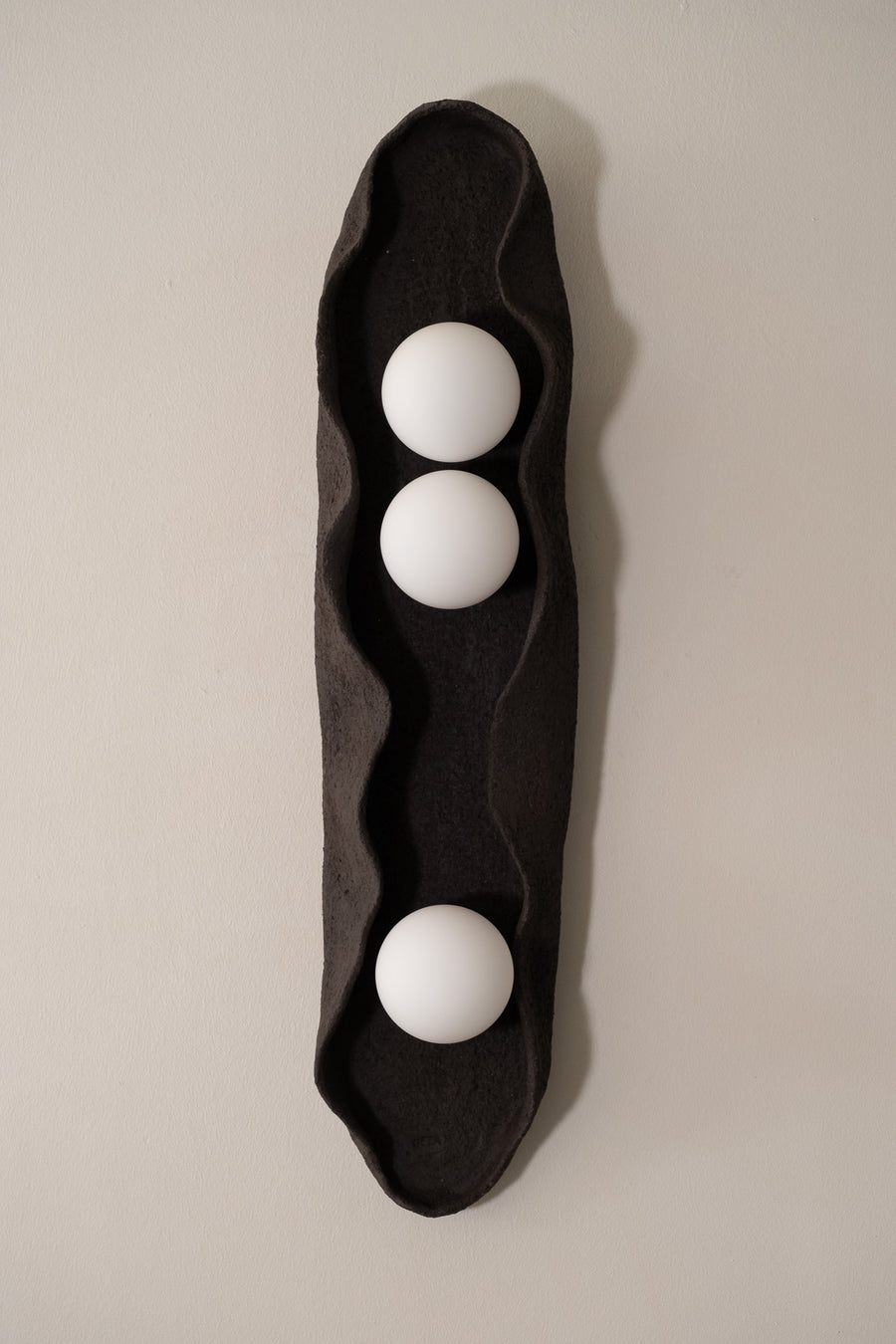 Noa – handmade black ceramic wall sconce in natural stoneware clay by Geza Ceramic Studio