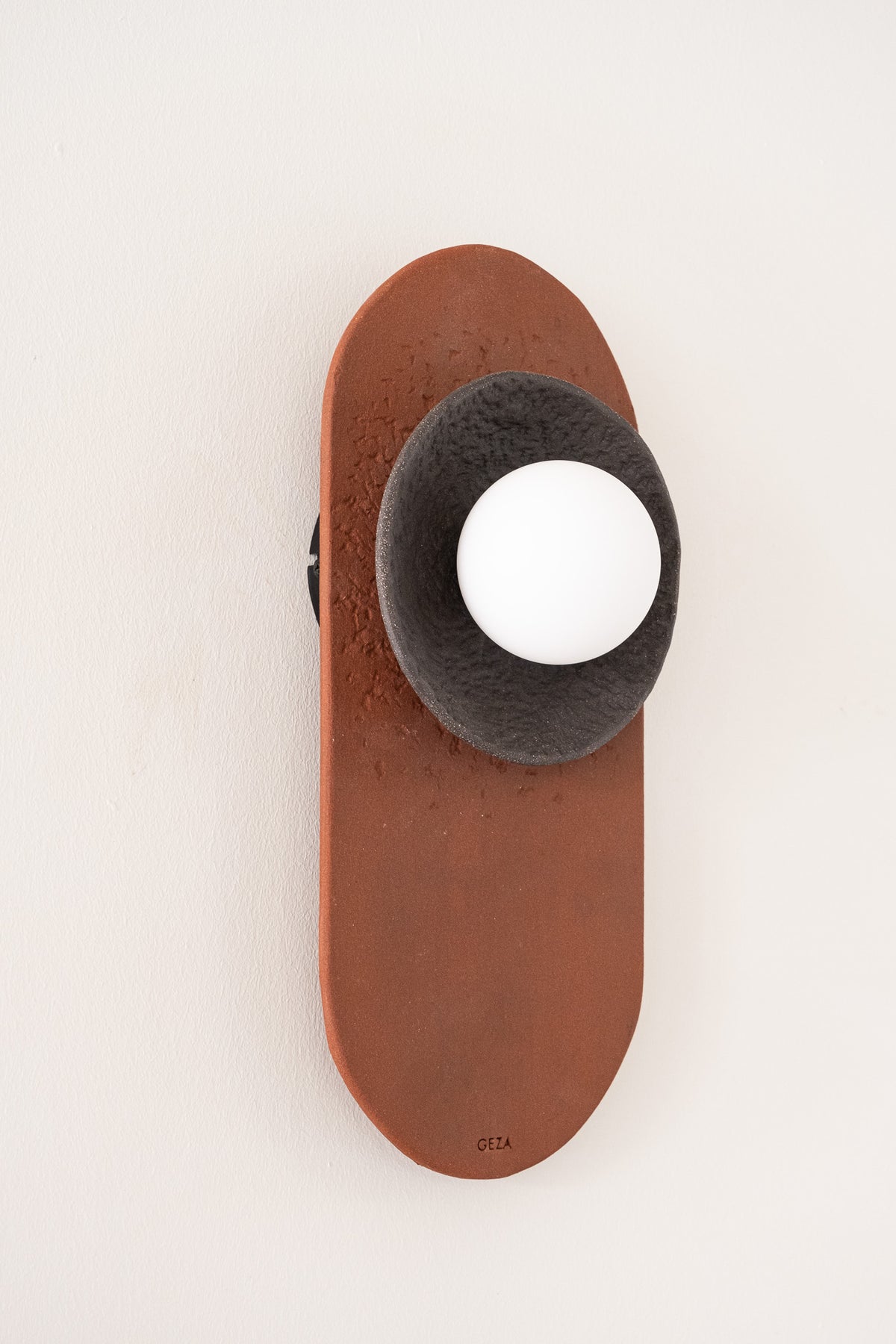 Nami – handmade terracotta & black ceramic wall sconce in natural stoneware clay by Geza Ceramic Studio