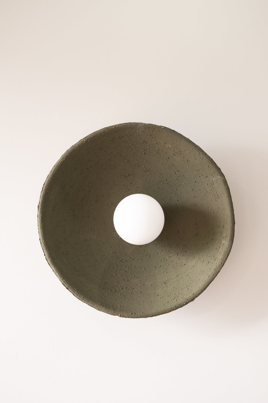 Sora – handmade dark green ceramic wall sconce in natural stoneware clay by Geza Ceramic Studio